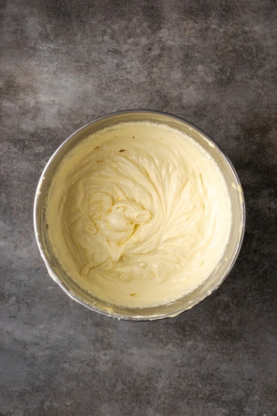 Flourless white chocolate cake batter in a metal mixing bowl.