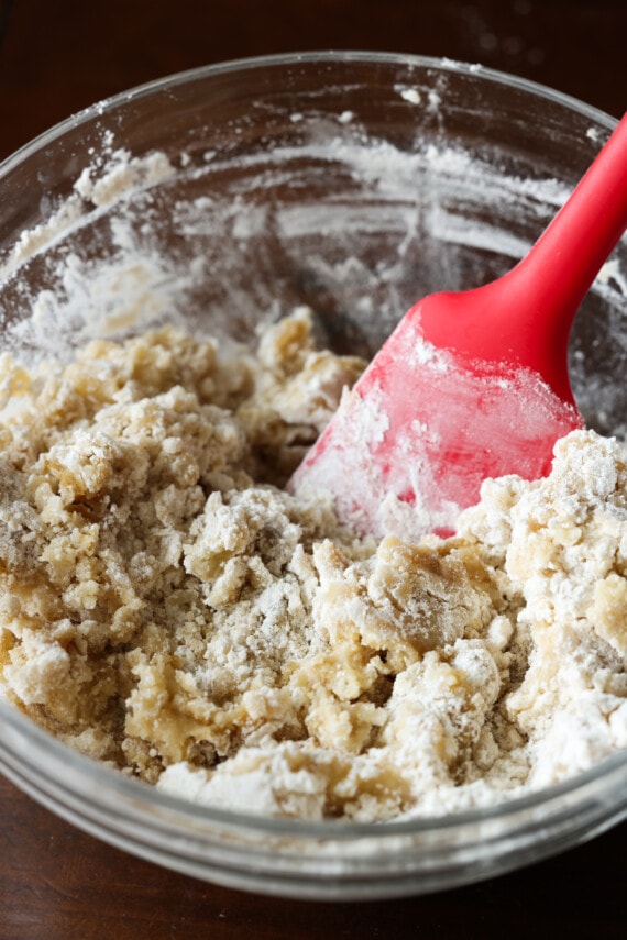mixing flour, sugar, and melted butter together in a glass bowl for crumb topping