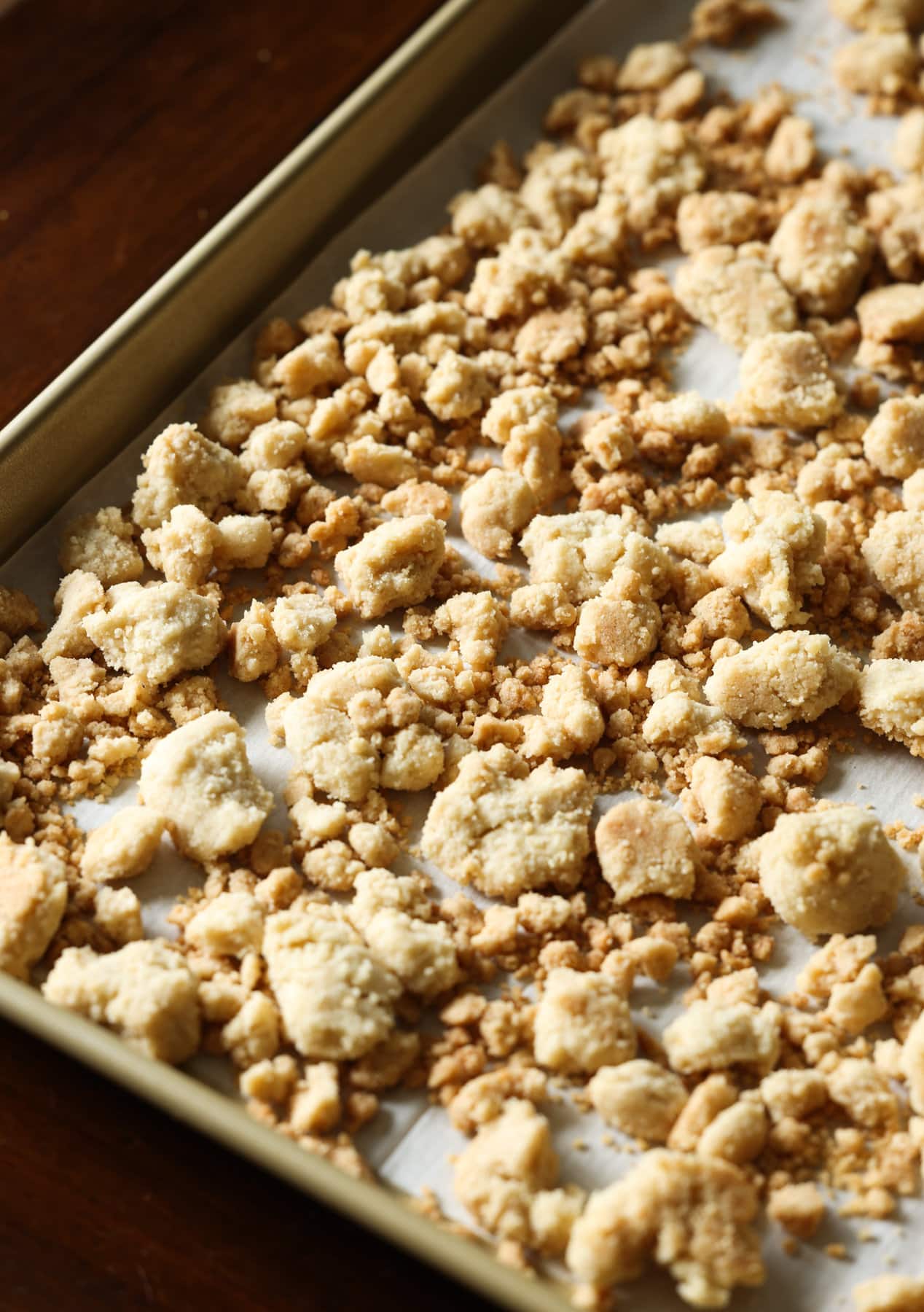 Crunchy Crumble topping baked on a parchment lined baking sheet