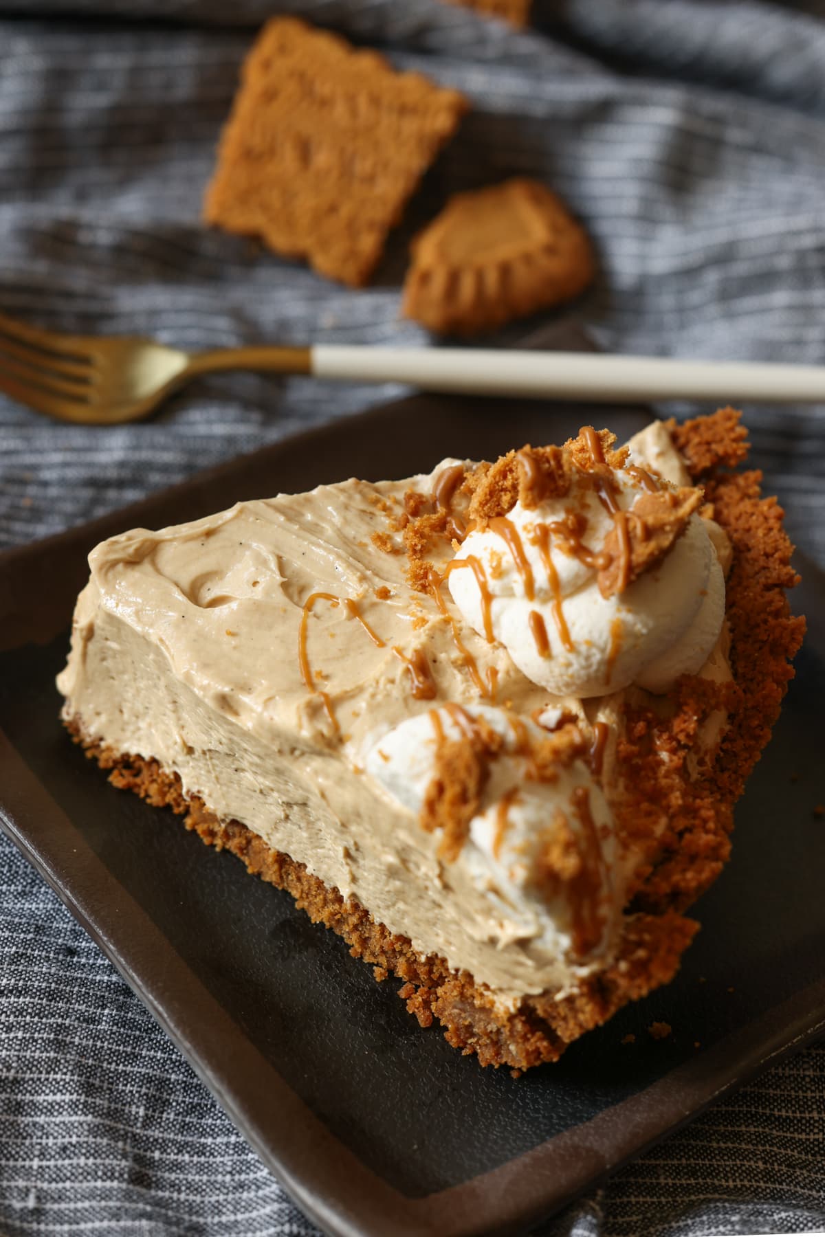 Cookie Butter Pie on a plate with whipped cream