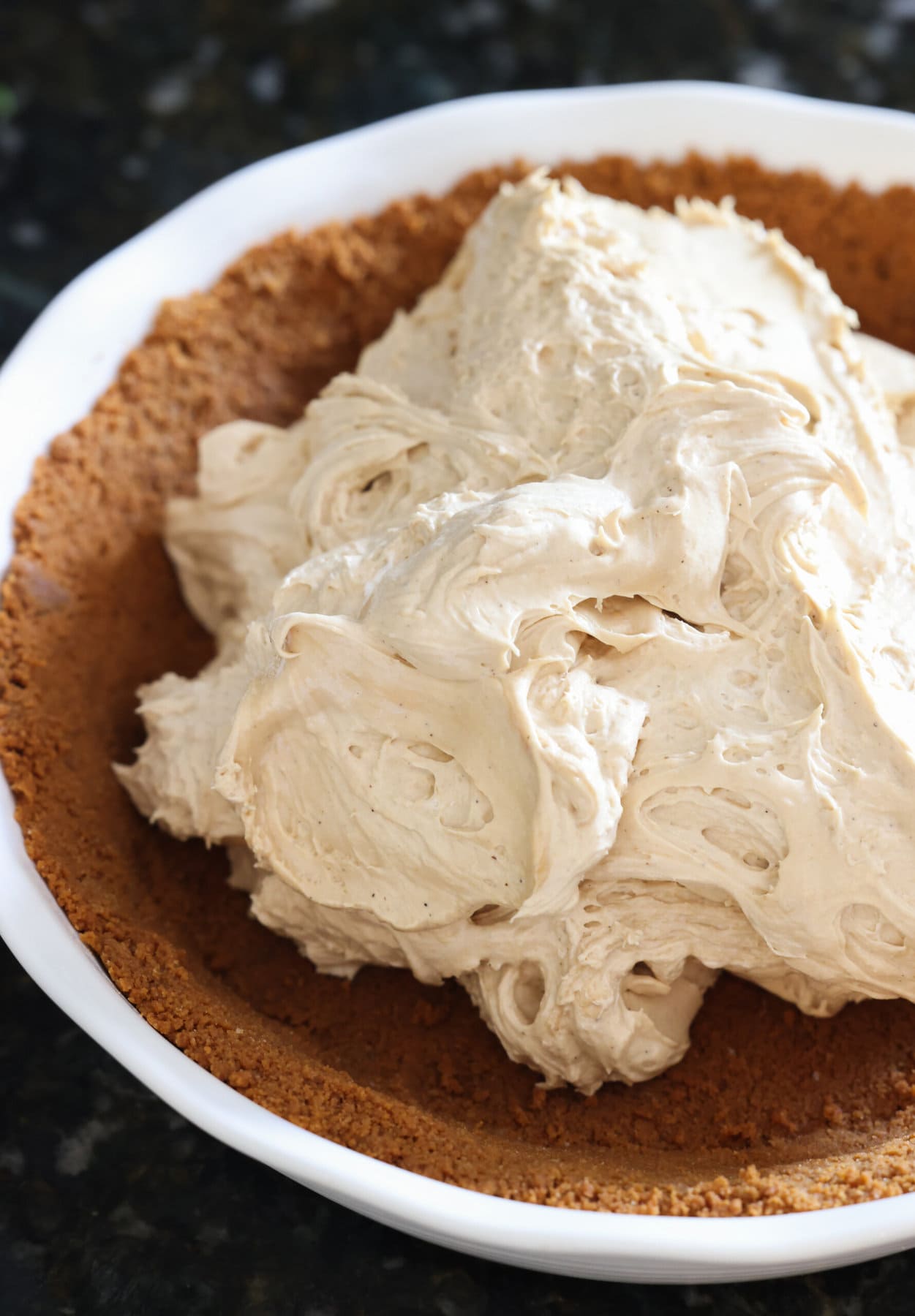 fluffy mousse in a cookie pie crust before being spread