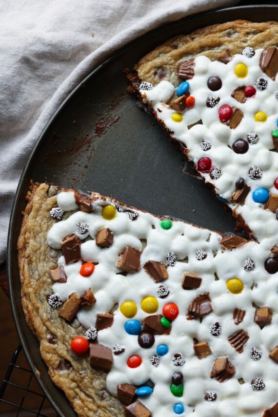 A cookie pizza from above with a slice missing