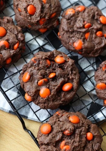 Chocolate Brownie Cookies on a wire rack filled with orange M&Ms