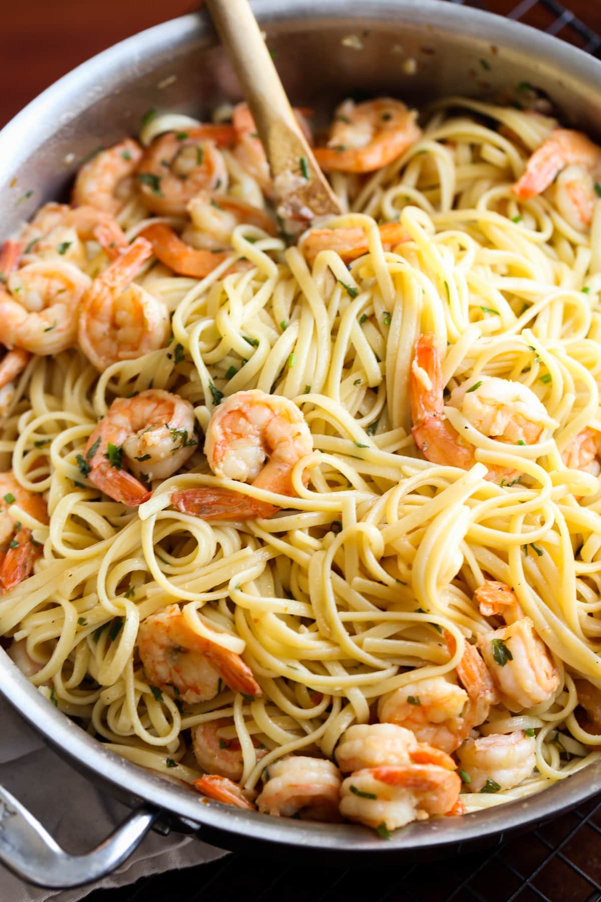 Shrimp scampi in a pan with linguine.