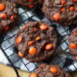 Chocolate Brownie Cookies on a wire rack filled with orange M&Ms