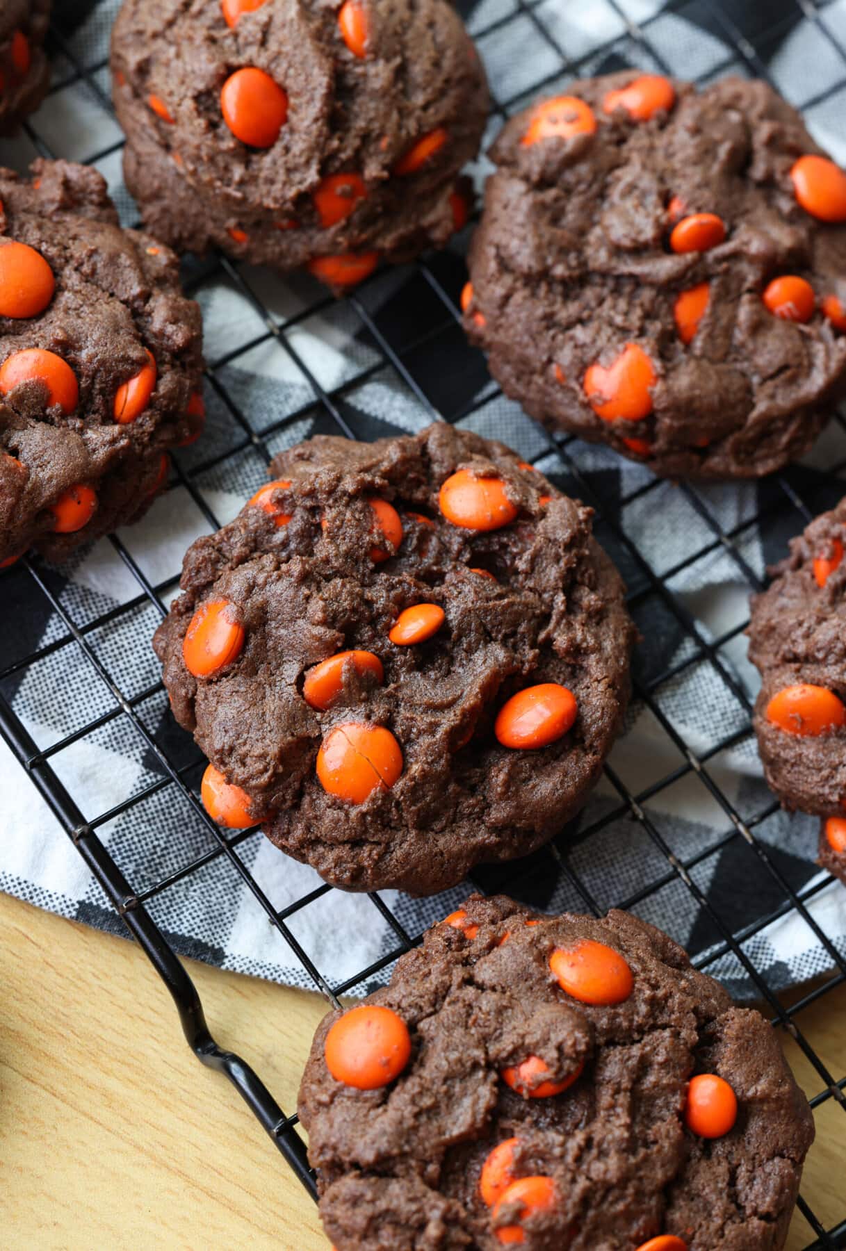 Chocolate Brownie Cookies on a wire rack filled with orange M&Ms