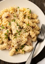 Overhead view of a bowl of Buffalo Wild Wings garlic parmesan chicken pasta with a fork.