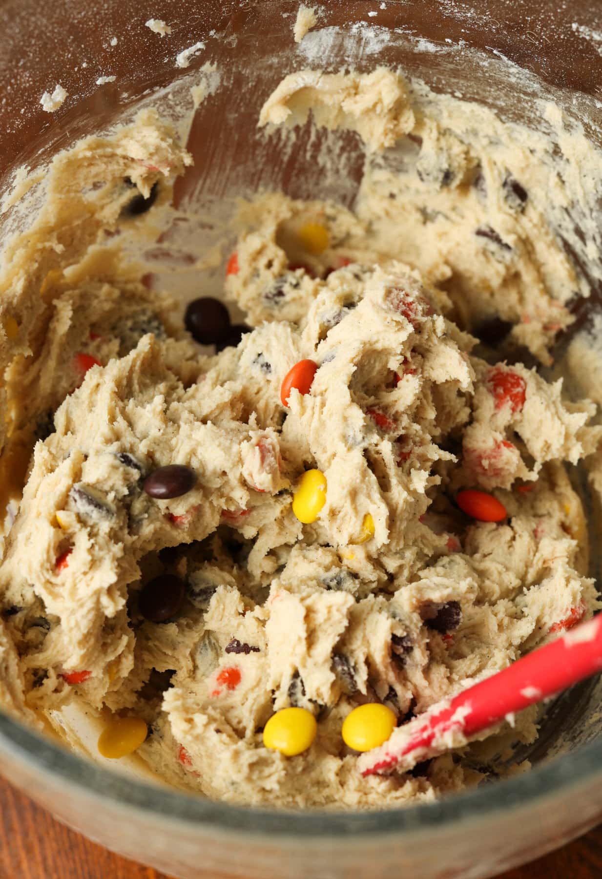 Cookie dough in a mixing bowl with M&Ms