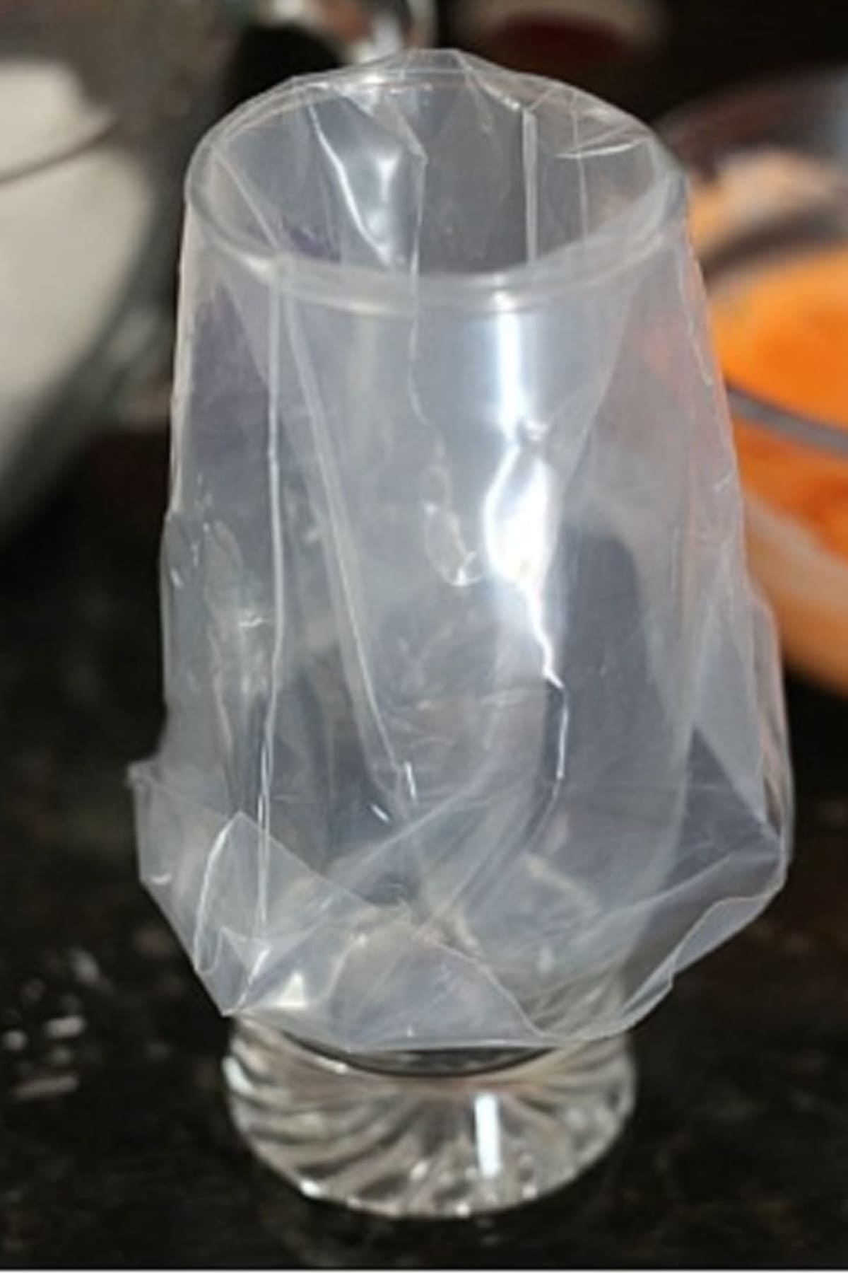 A piping bag in a glass cup folded over the edge ready to fill with frosting