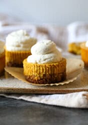 Mini Pumpkin Cupcake-style Cheesecakes on a serving plate unwrapped