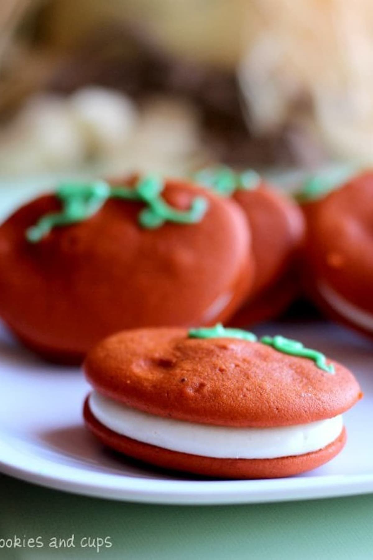 Close up of pumpkin whoopie pies on a white plate.