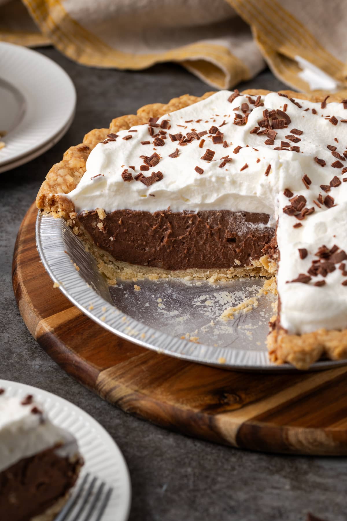 Chocolate pudding pie in a pie plate with a slice missing.