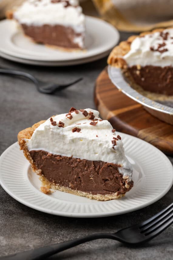 A slice of chocolate pudding pie on a white plate.