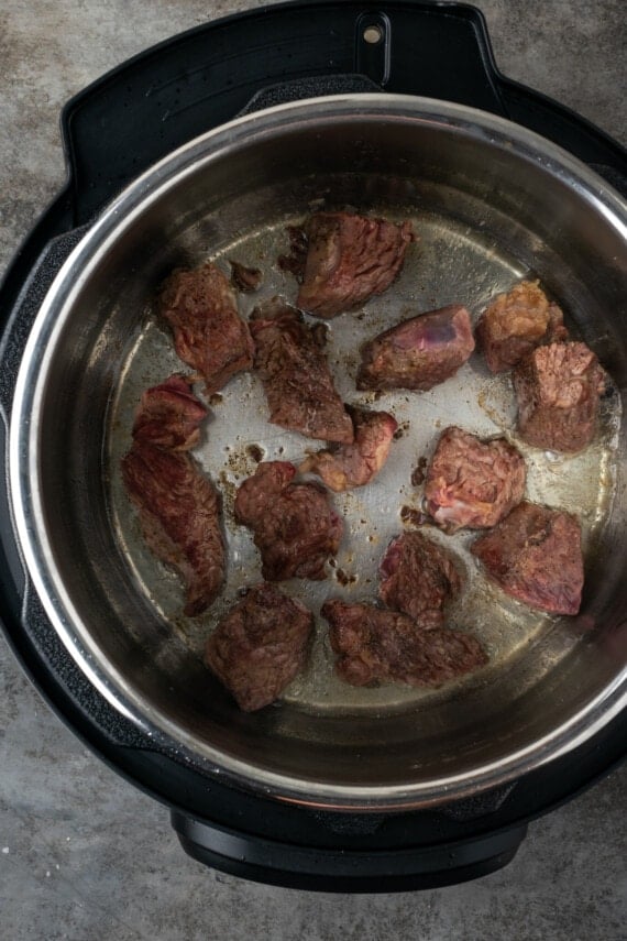 Beef cubes sauteing inside the instant pot.