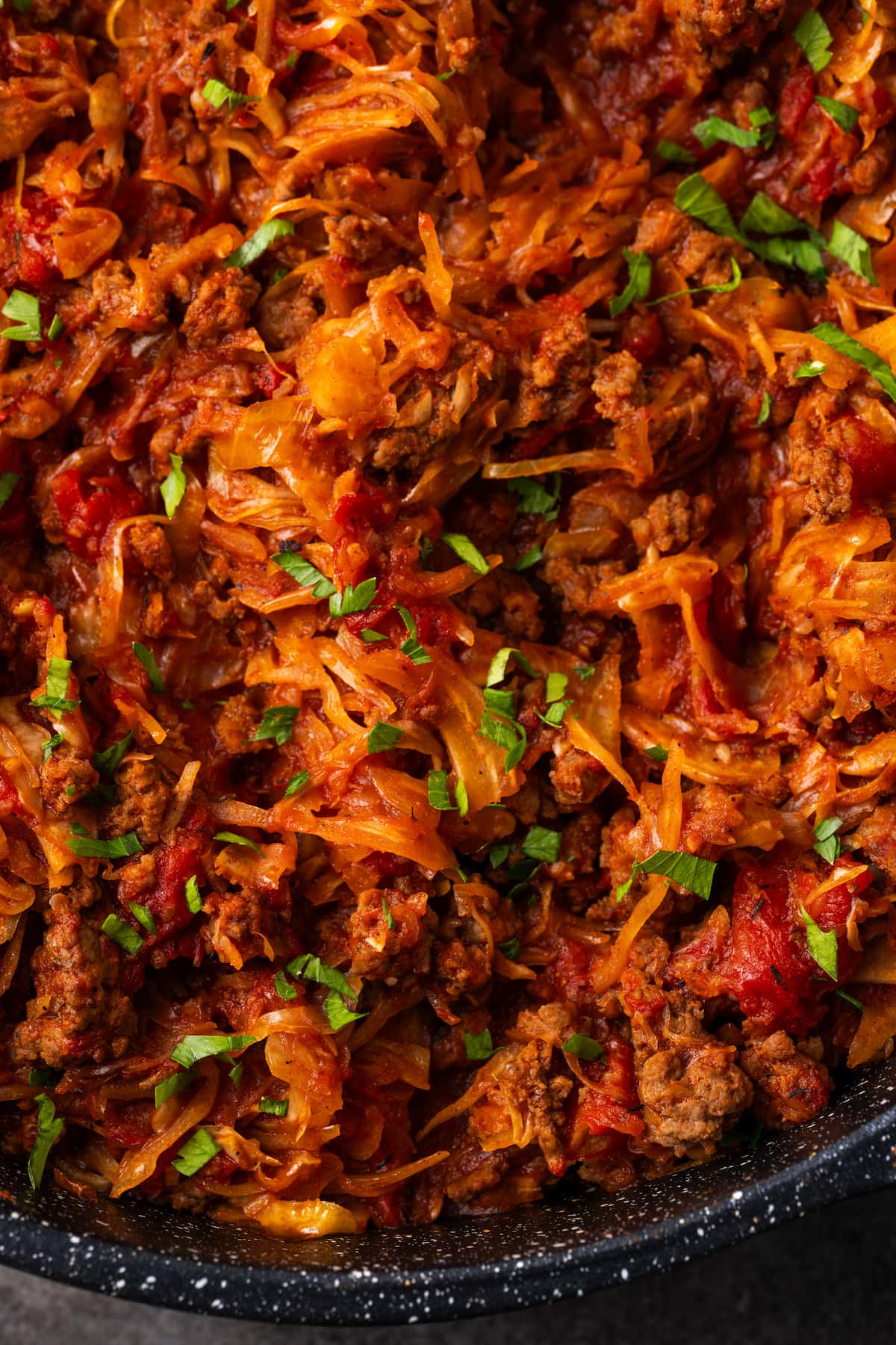 Close up of unstuffed cabbage in a skillet.