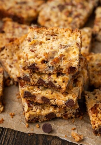 Close up of a stack of magic bars surrounded by more bars on a piece of parchment paper.