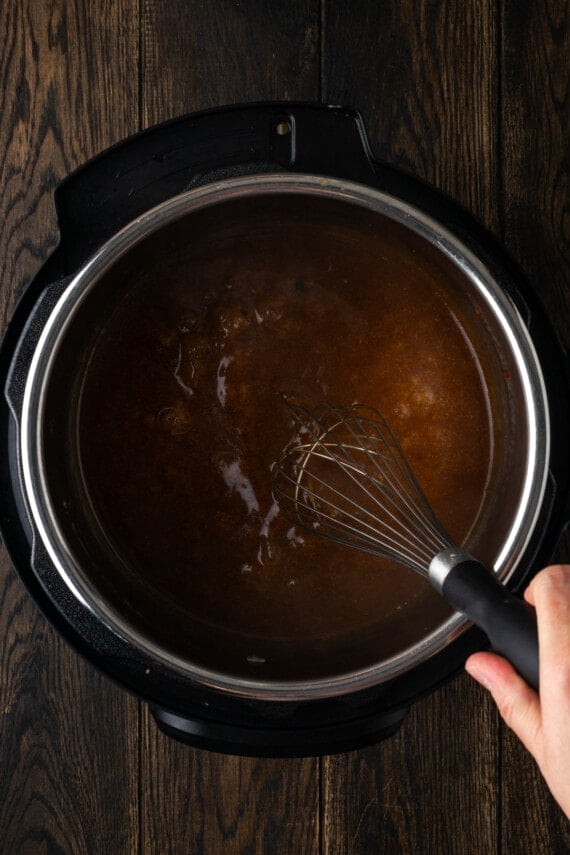 Instant Pot pork chops are tender, juicy, and full of flavor. Make a quick gravy out of the leftover cooking sauce for an easy weeknight meal! A slurry whisked into the leftover sauce inside the instant pot.