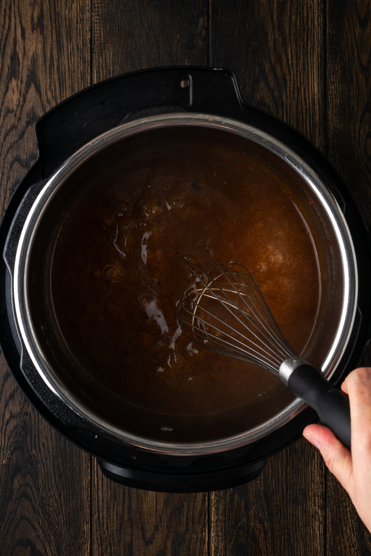 A slurry whisked into the leftover sauce inside the instant pot.