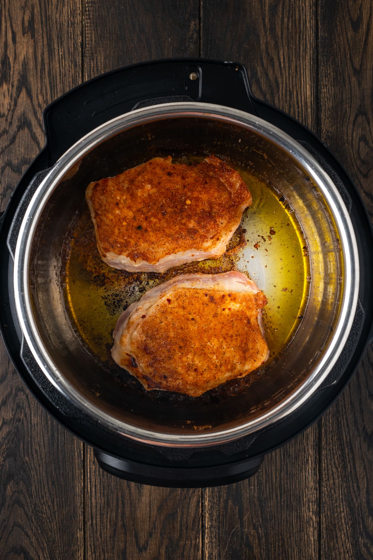 Seared pork chops inside the instant pot.
