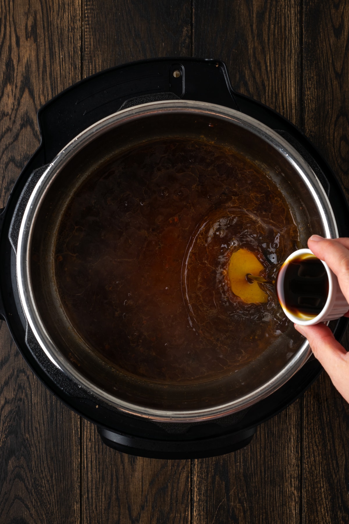 Worcestershire sauce poured into stock inside the instant pot.