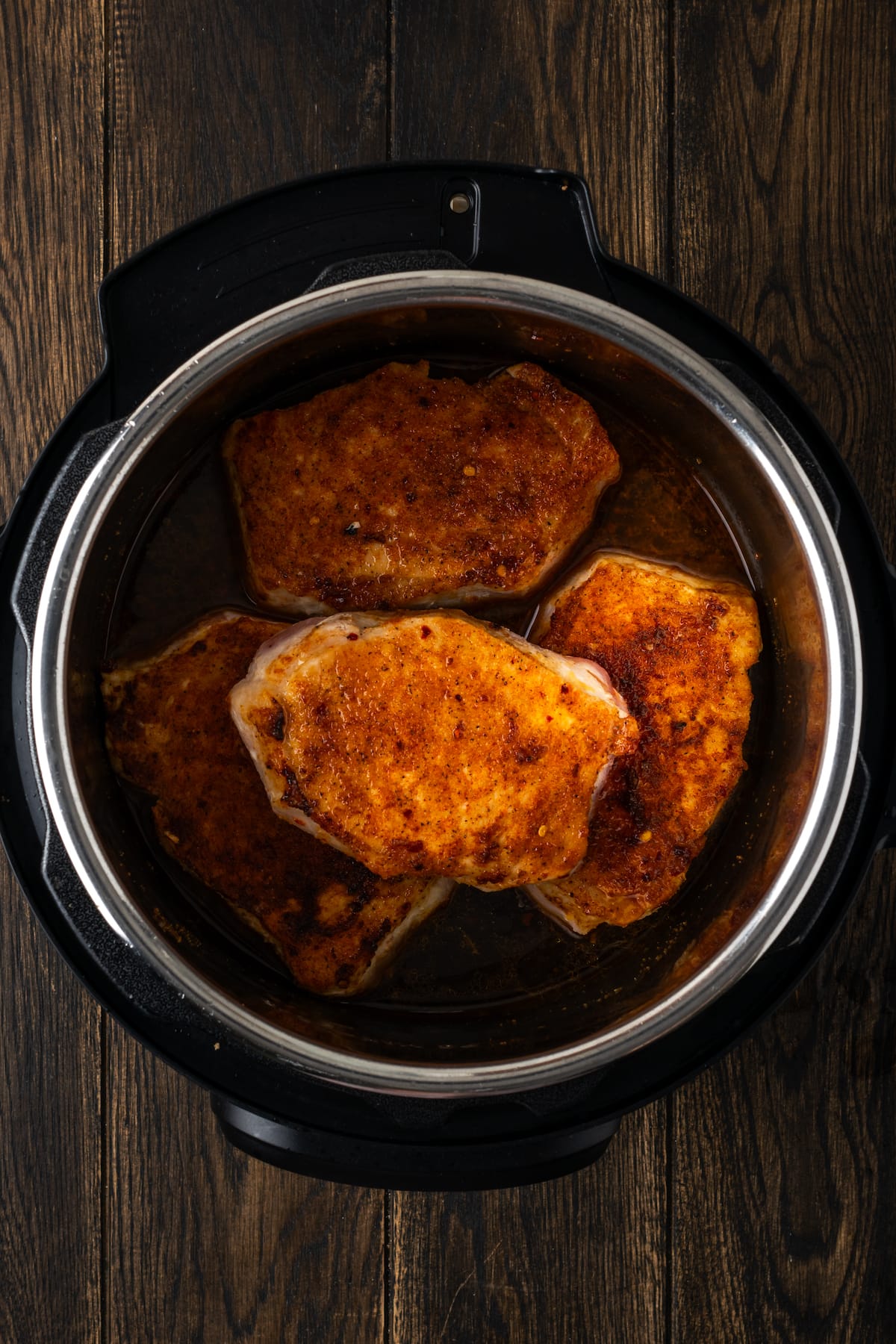 Cooked pork chops inside the instant pot.