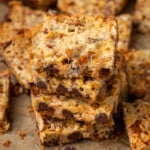 Close up of a stack of magic bars surrounded by more bars on a piece of parchment paper.