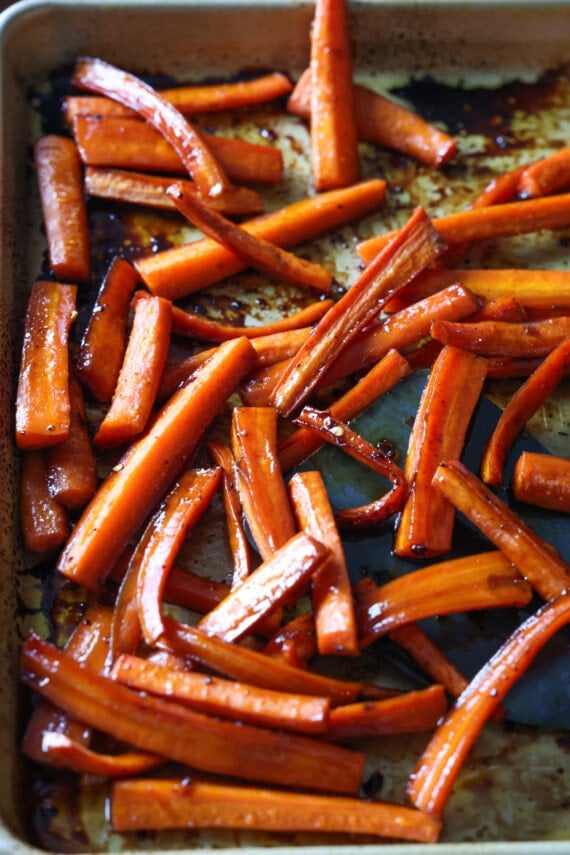 Roasted carrot sticks on a baking sheet