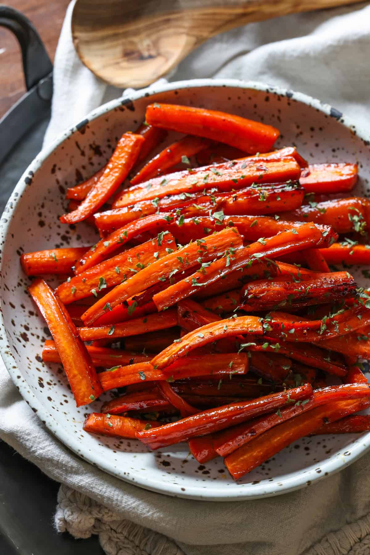 Roasted carrots in a bowl topped with parsley