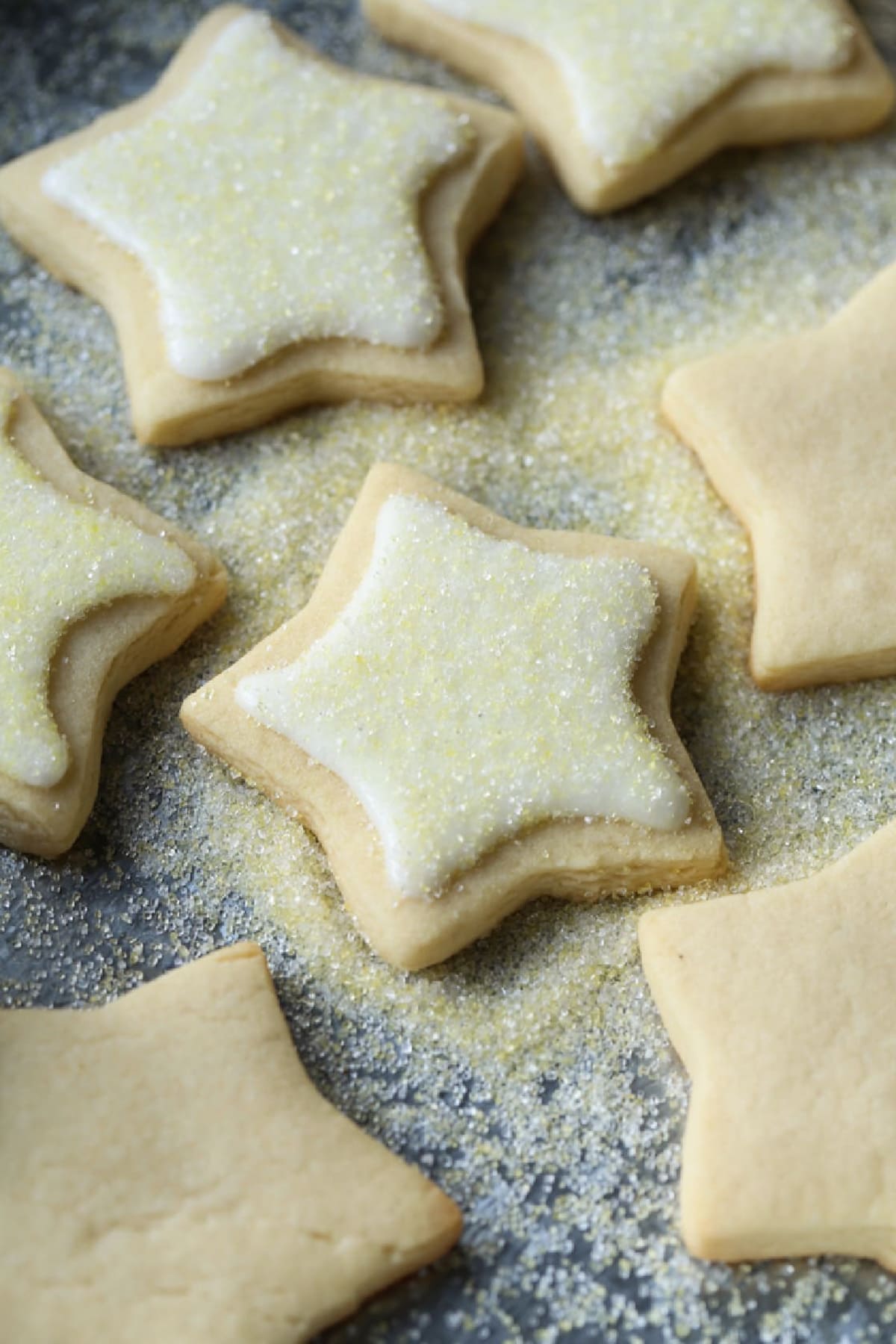 Cut Out Sugar Cookies cut into star shapes iced and dusted with yellow decorating sugar.