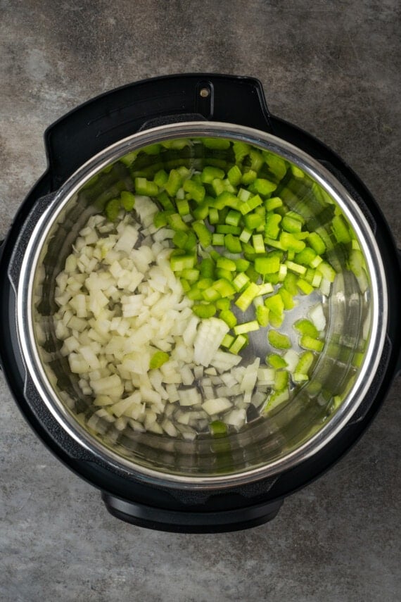 Diced celery and onion inside the instant pot.