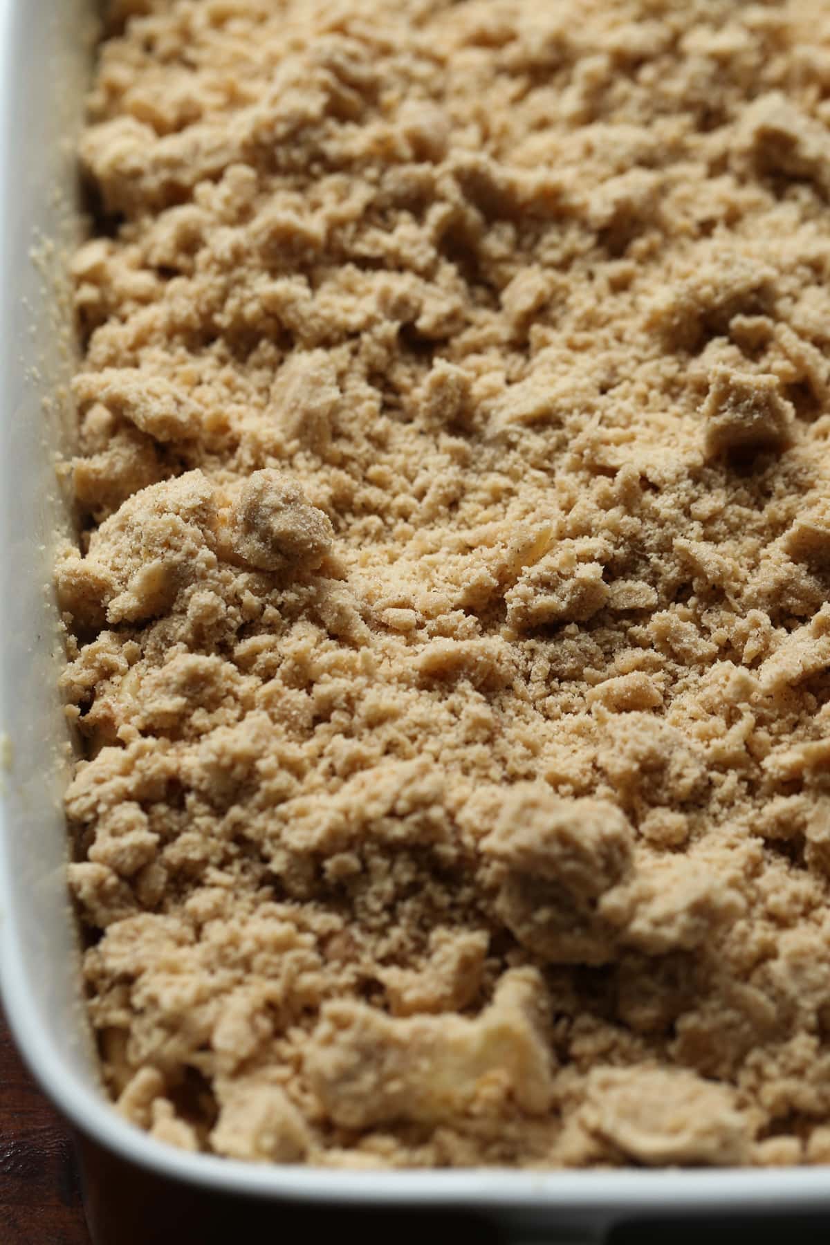 Crumb topping on top of coffee cake batter in a 9x13 baking dish before going into the oven.