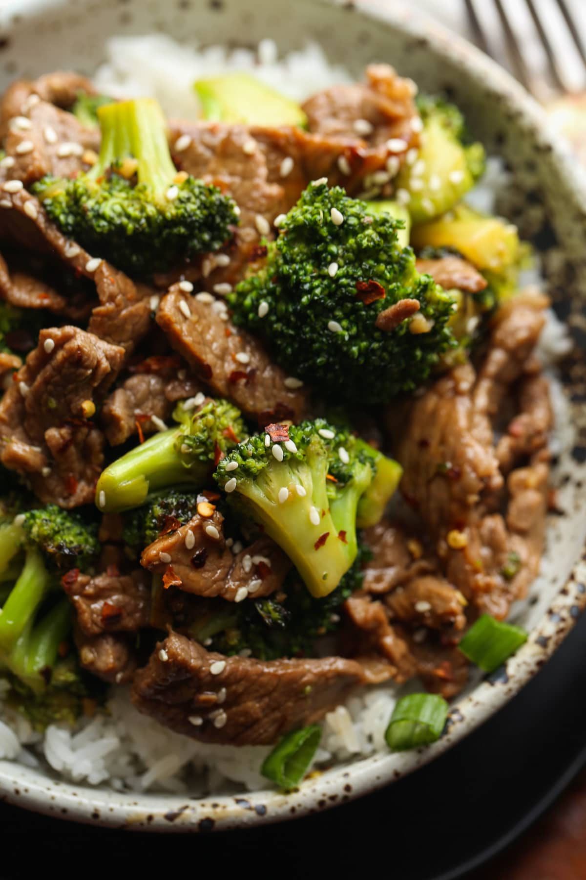 Plate of beef and broccoli over rice.