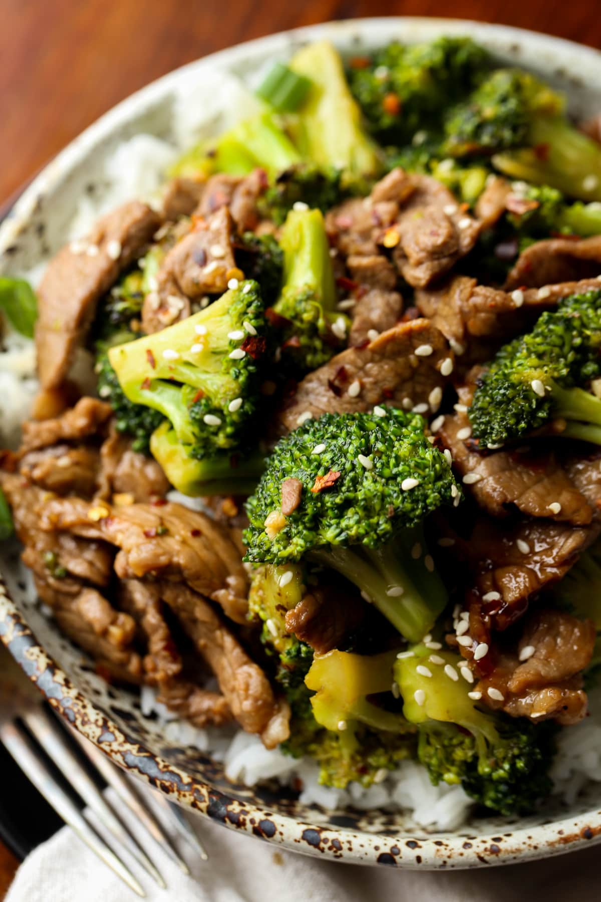 Steak slices and broccoli on a plate with white rice