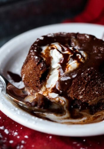 Chocolate Lava Cake topped with vanilla ice cream and overflowing with molten chocolate