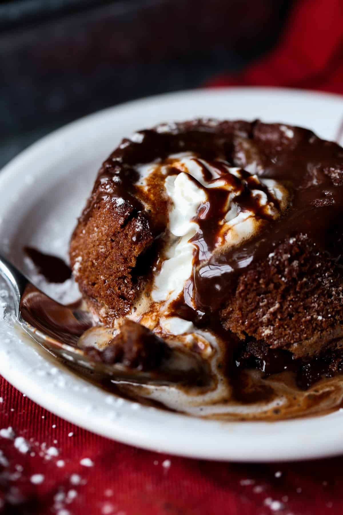 Chocolate Lava Cake topped with vanilla ice cream and overflowing with molten chocolate