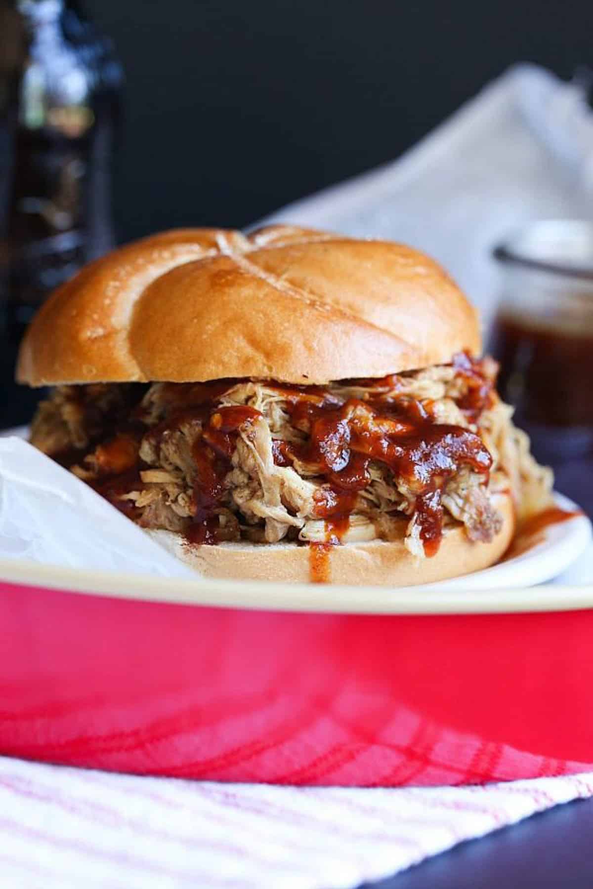 Root beer pulled pork sandwich on a red serving tray