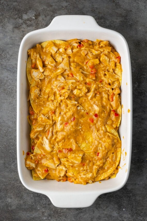 Partially assembled King Ranch chicken in a casserole dish.