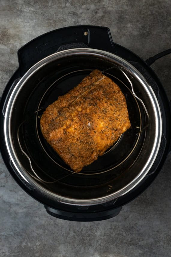This juicy Instant Pot pork loin is smothered with a savory spice rub and out-of-this-world tender. Sear and cook your pork all in one pot! Cooked pork loin roast inside the instant pot.