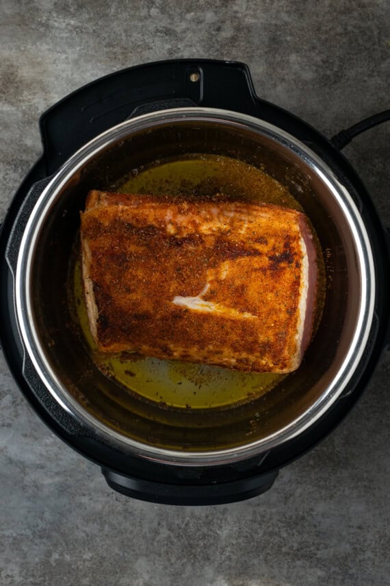This juicy Instant Pot pork loin is smothered with a savory spice rub and out-of-this-world tender. Sear and cook your pork all in one pot! Seared pork loin roast inside the instant pot.