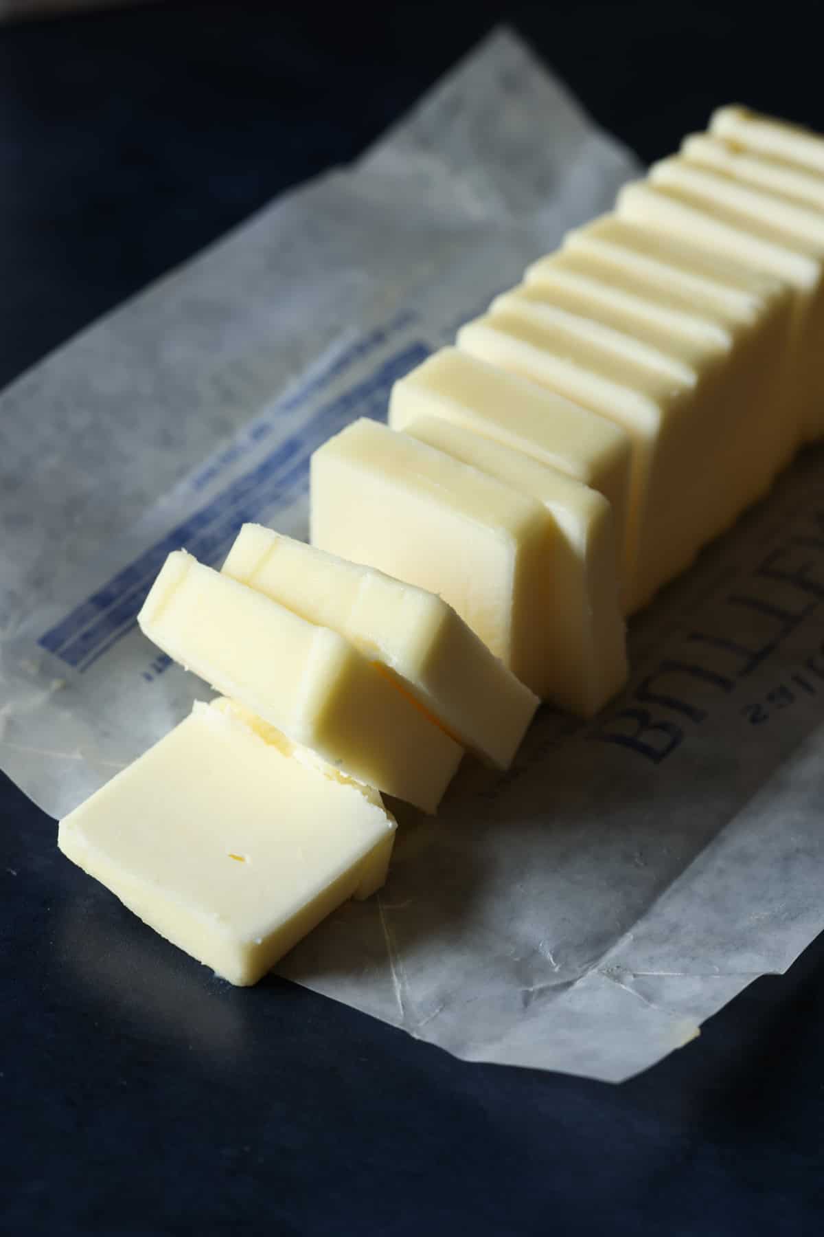 A stick of butter but into slices on the butter wrapper.