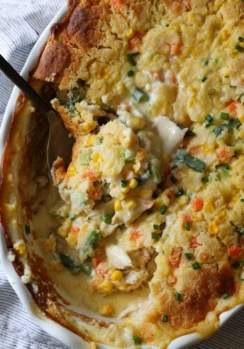 TikTok Chicken Cobbler casserole baked in a round dish with a spoon scooping out a portion