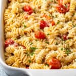 Baked Boursin cheese pasta in a white ceramic casserole dish.