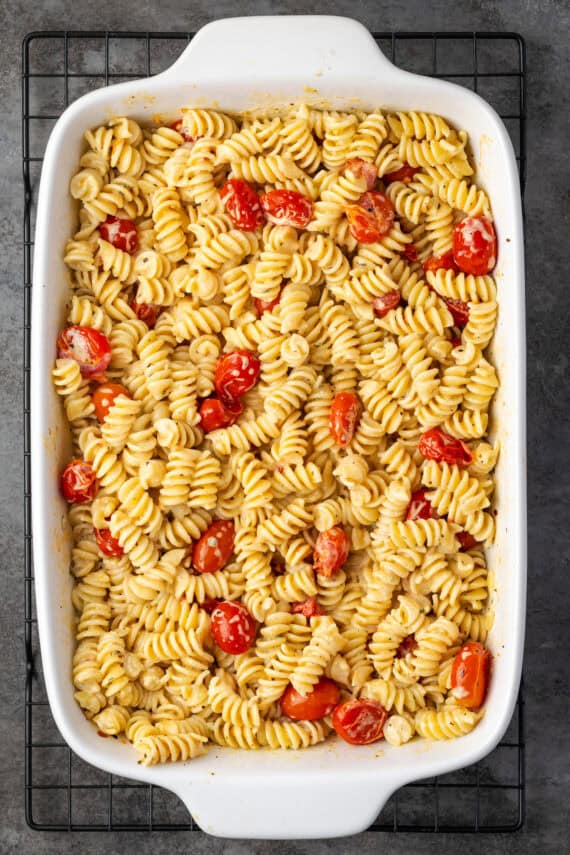 Overhead view of pasta with Boursin cheese in a white ceramic casserole dish.