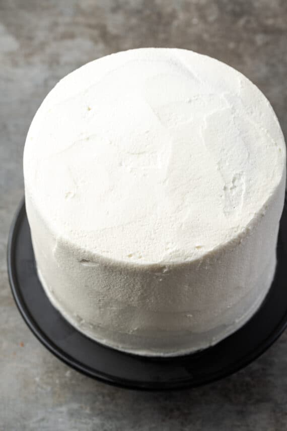 A layer cake covered with vanilla frosting.