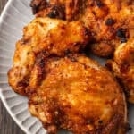 Close up of air fryer chicken thighs on a platter.