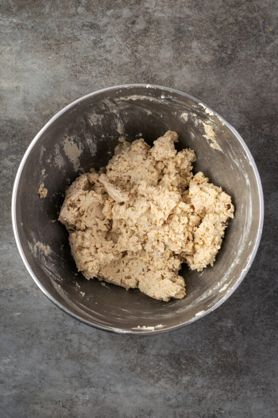 Cookie dough combined in a metal bowl.