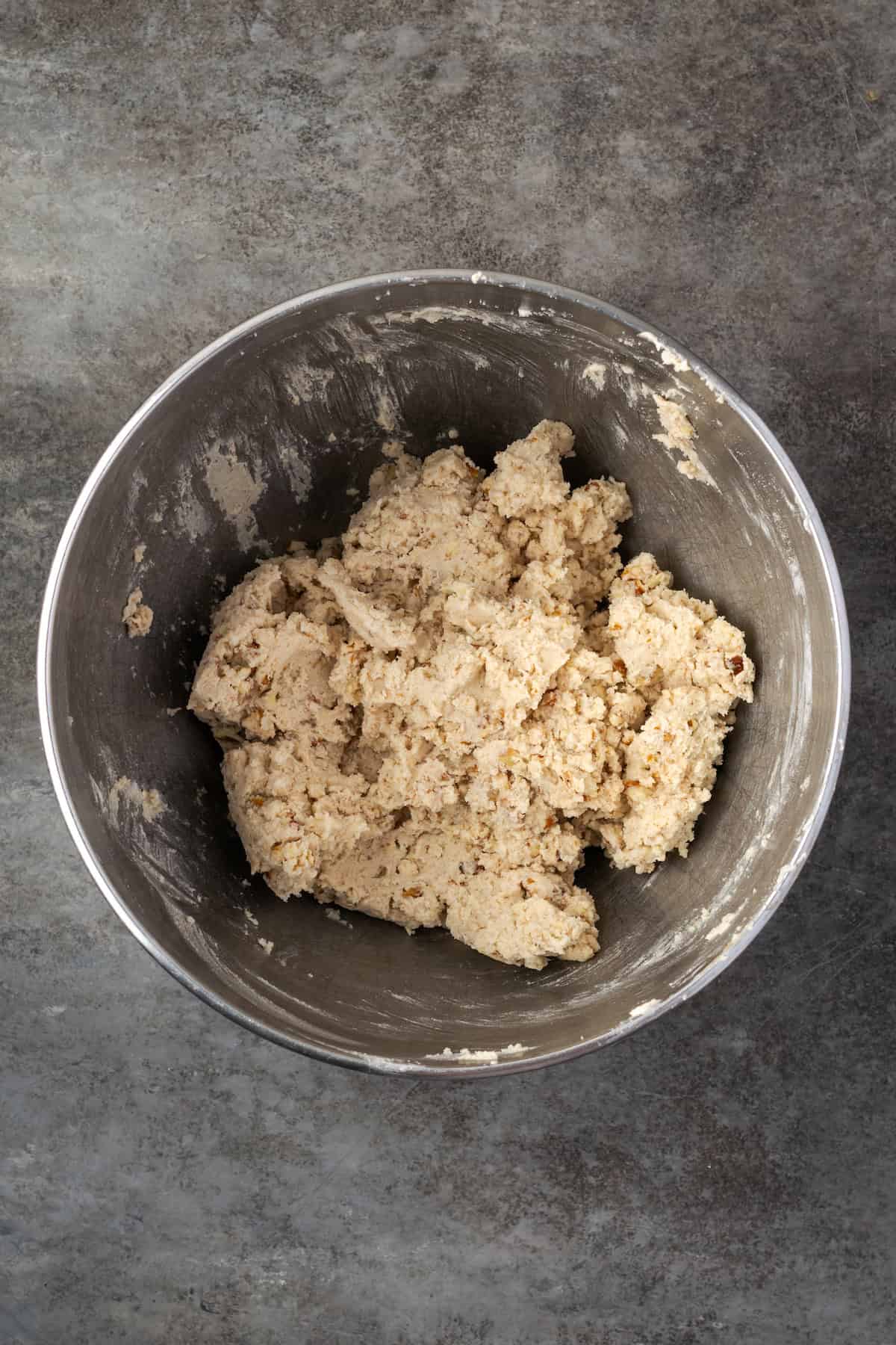 Pecan sandies are buttery, crumbly shortbread cookies with crispy edges and plenty of nutty crunch. They make great Christmas cookies! Cookie dough combined in a metal bowl.