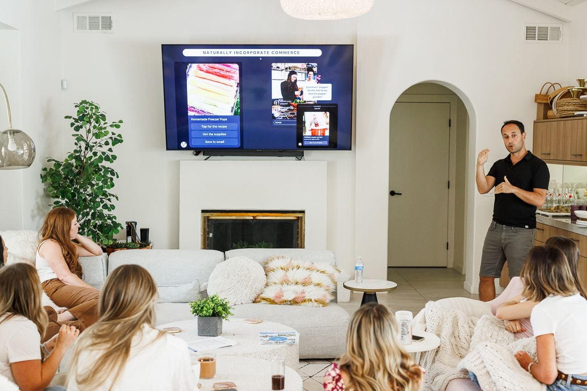 The girls are sitting in the living room listening to a presentation about grocery lists