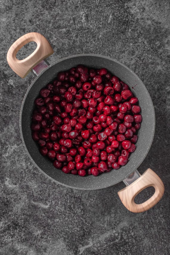 Cherries added to a large pot.