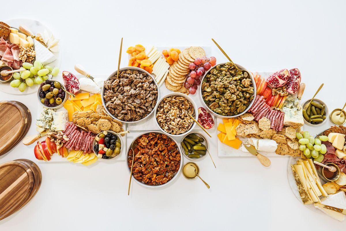 Walnuts and charcuterie items on a white table